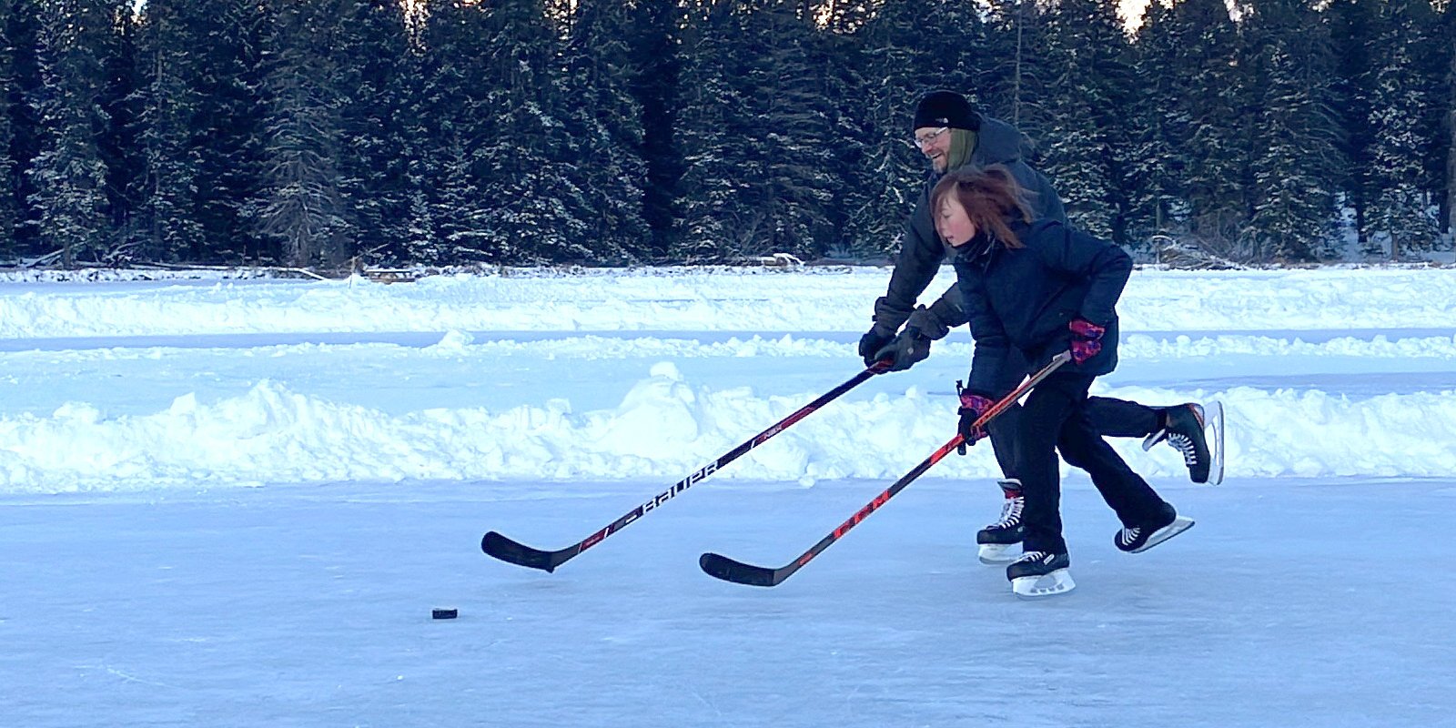 Ollie and Jamie playing ice hockey in Canada